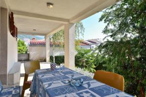 a table with a blue table cloth on a patio at Apartments Goran - 150m from sea in Brela