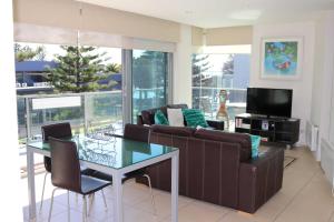 a living room with a couch and a glass table at 507 At The Waves in Cowes