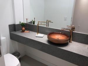 a bathroom with a bowl sink on a counter at Gramado - Centro - Apto Novo in Gramado +17 photos