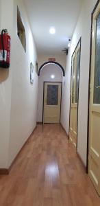 an empty hallway with a door and a wooden floor at Hostal Loyola in Madrid