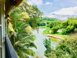 a view of a river from a balcony at Jenushi homestay in Kandy