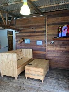 a room with a bed and a tv on a wall at Spheredivers Scuba & Leisure in Pulau Mabul 