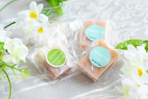 a group of three pieces of soap on a table with flowers at Villa de Class in Osaka