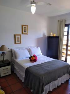 a bedroom with a bed with a stuffed animal on it at Pousada da Lagoa in Florianópolis