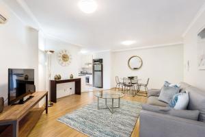 a living room with a couch and a table at Inner city retreat in Pyrmont 1 bdrm with Car space - 28 Mill in Sydney