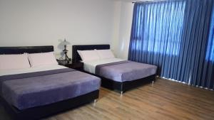 Postel nebo postele na pokoji v ubytování Tata House B&B