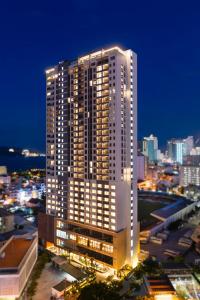 a tall building in a city at night at DQua Hotel in Nha Trang