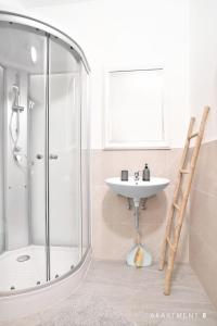 a bathroom with a shower, sink, and tub at Downtown Apartment / Free Parking in Ljubljana