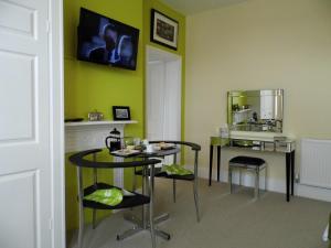 a dining room with two chairs and a table at Studios At Glenthorne in Merthyr Tydfil