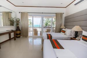 Postel nebo postele na pokoji v ubytování Sur Beach Resort Boracay