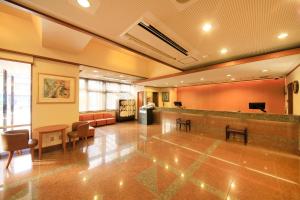a large lobby with a waiting room with a bar at Maple Inn Makuhari in Chiba