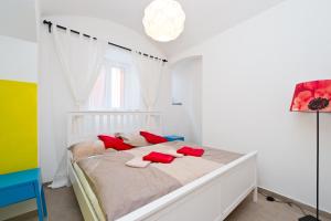 a bedroom with a bed with red pillows on it at Budget Apartment in Prague