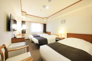 Tempat tidur dalam kamar di Maple Inn Makuhari