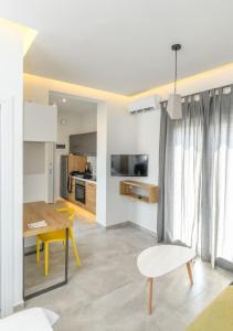 cocina y sala de estar con mesa y sillas en Superior modern apartment in the center with view. en Volos