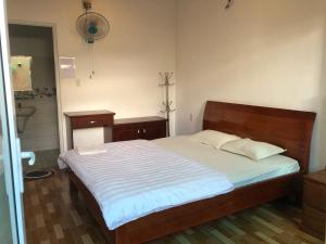 a bedroom with a bed and a sink at Thảo Chi in Bao Loc