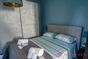 a bedroom with a bed with towels on it at Residenza Bolzoni Avio in Parma