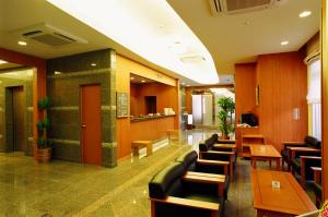 a restaurant with chairs and tables and a lobby at Hotel Route-Inn Nahatomariko in Naha