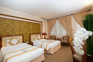 Postel nebo postele na pokoji v ubytování Palace Hotel Vung Tau