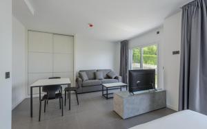 a living room with a couch and a table at Apartamentos Onzamar in Sanxenxo