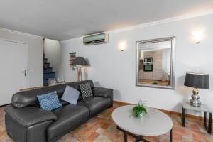 a living room with a couch and a table at My rima in Antibes