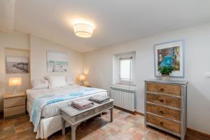a bedroom with a bed and a dresser and a window at My rima in Antibes