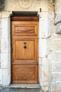 a wooden door in a stone building with a stone wall at My rima in Antibes