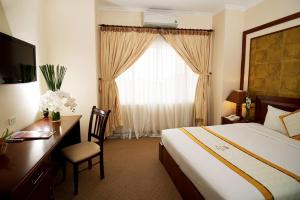 Postel nebo postele na pokoji v ubytování Palace Hotel Vung Tau