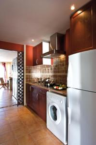 a kitchen with a stove, refrigerator, sink and dishwasher at Studio Orient Bay in Orient Bay