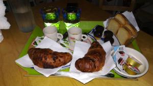 a tray of food with sausage and bread on a table at B&B Ninfa in Caserta +8 photos