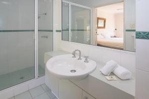 a white bathroom with a sink and a shower at Bayshore Beachside Resort in Dunsborough +132 photos