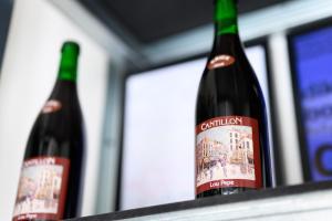 two bottles of wine sitting on a shelf at Hotel La Grande Cloche in Brussels