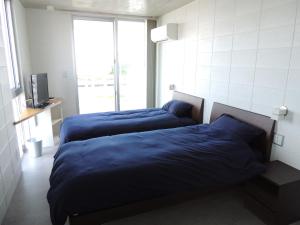 Postel nebo postele na pokoji v ubytování Umi no Yado Umikaze + 17 fotografií