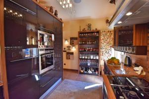 a kitchen with a large black refrigerator and a counter at Apartment President in Zagreb