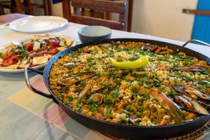 a large pan of food on a table at Pousada e Restaurante Tremembé in Icapuí