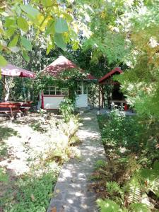 a garden with a pavilion and a walkway at PENSIUNEA STEFANIA in Brebu Mînăstirei