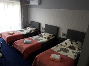 A bed or beds in a room at H-Odra Nowa Sól