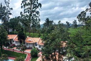a house in the middle of a tea plantation at Sandalo Castle Resorts in Gūdalūr