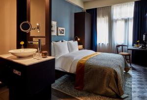 a hotel room with a bed and a sink at Park Centraal Amsterdam, part of Sircle Collection in Amsterdam