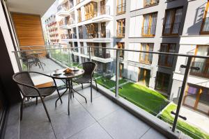 a balcony with a table and chairs in a building at NOVUM Apartment in Krakow
