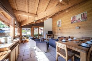 a dining room with a table and a couch at Aiglon Morzine in Morzine