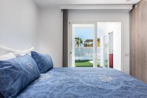 a bedroom with a bed with blue pillows at Luxurious 5* VILLA - 300M2 - private HEATED pool - garage - WiFi in Palm-mar +48 photos