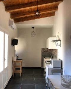 a kitchen with wooden ceilings and a stove top oven at Allura - Casa Vacanza in Scicli +27 photos
