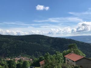 a view of a mountain with houses and trees at la source d'en haut in Valcivières