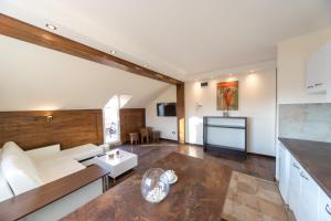 a living room with a couch and a table at New and Nice apartments in Kragujevac
