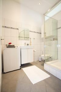 a white bathroom with a sink and a shower at ROMEO & JULIA ZENTRAL in Bamberg
