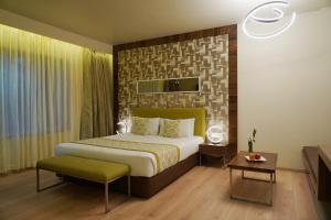 a bedroom with a king sized bed in a room at IRA By Orchid Bhubaneswar in Bhubaneshwar