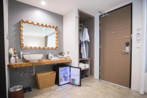 a bathroom with a sink and a mirror at Deevana Krabi Resort in Ao Nang Beach