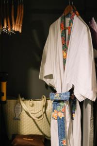 a white shirt and a tie hanging on a hanger at Deevana Krabi Resort in Ao Nang Beach