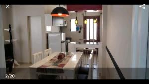 a kitchen with a table and chairs in a room at Luz de faro in Mar del Plata