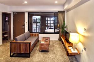 a living room with a couch and a table at Deevana Krabi Resort in Ao Nang Beach